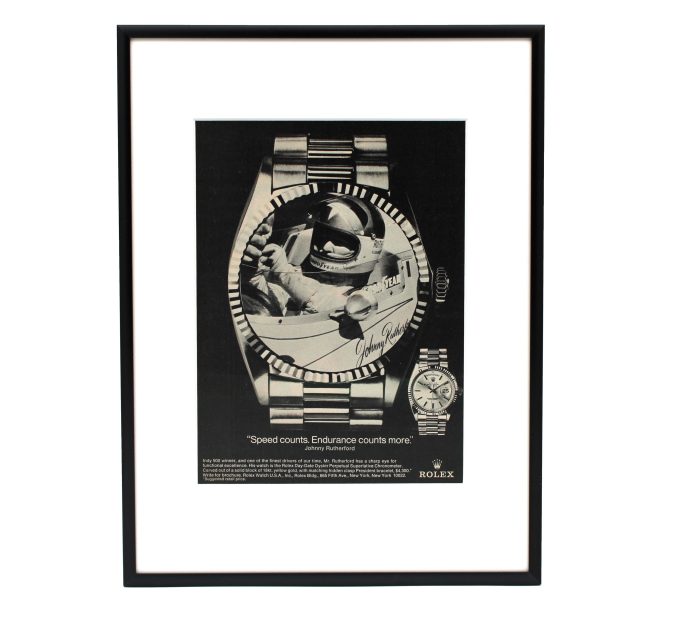 Authentic framed 1981 Rolex Day-Date Johnny Rutherford "Speed counts. Endurance counts more." Print Ad